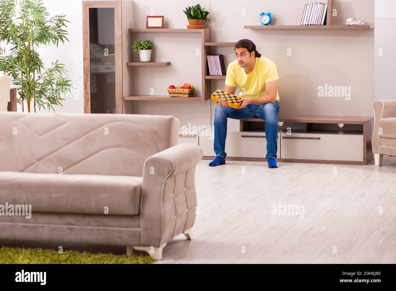 Young man student boring at home during pandemic Stock Photo