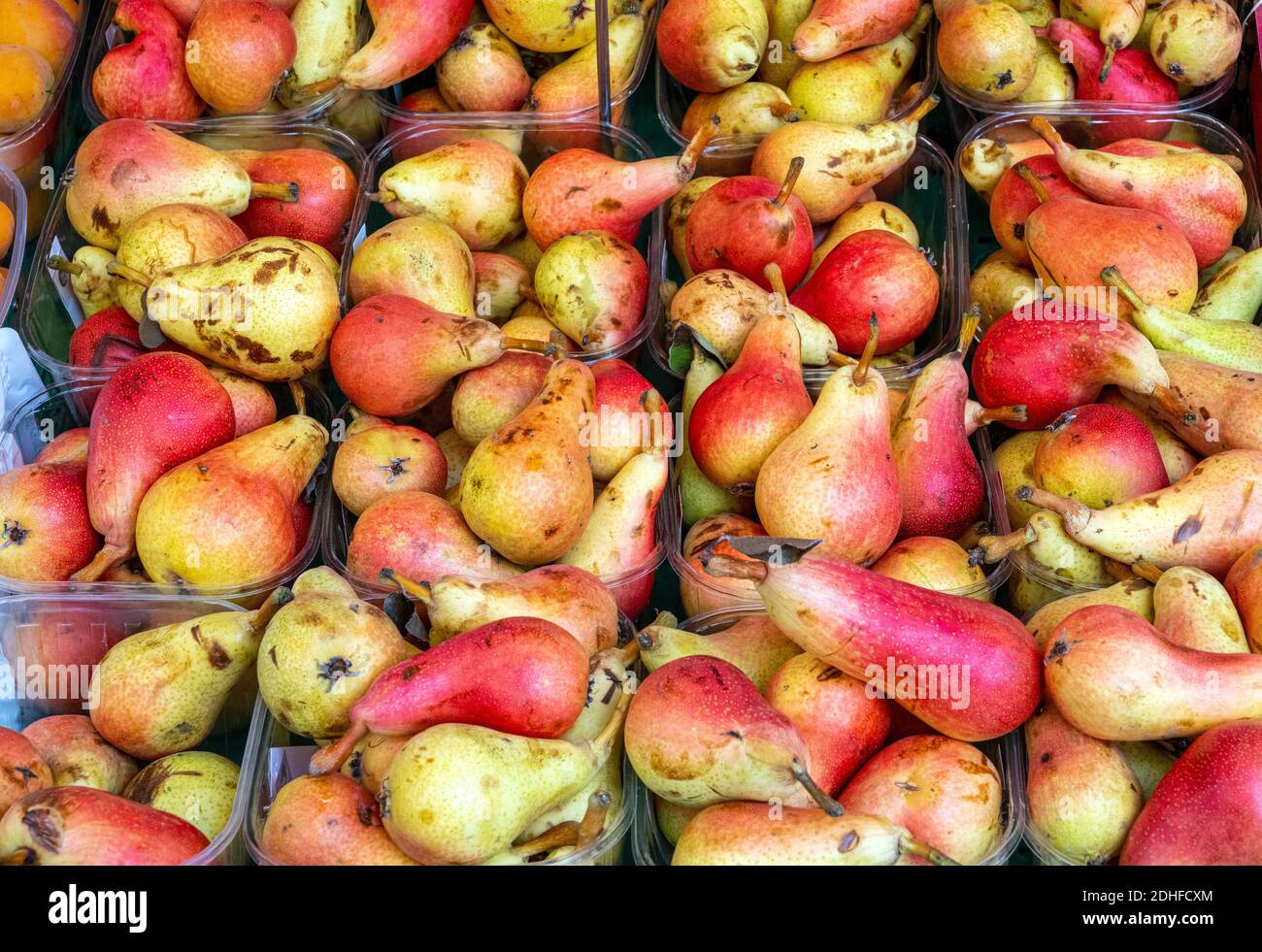 Red and yellow pears for sale at a market Stock Photo