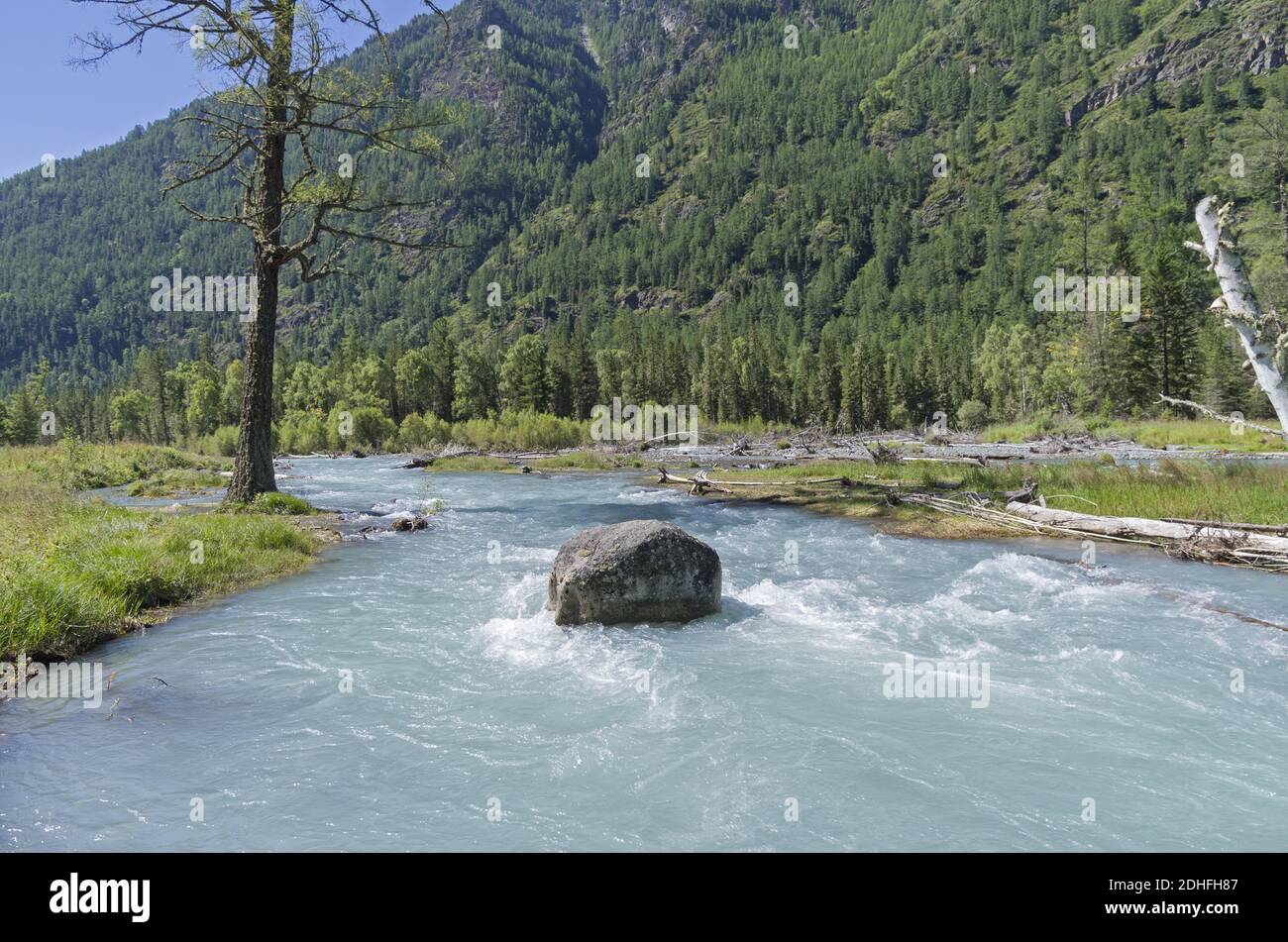 Big rock in the middle of a mountain river. Stock Photo