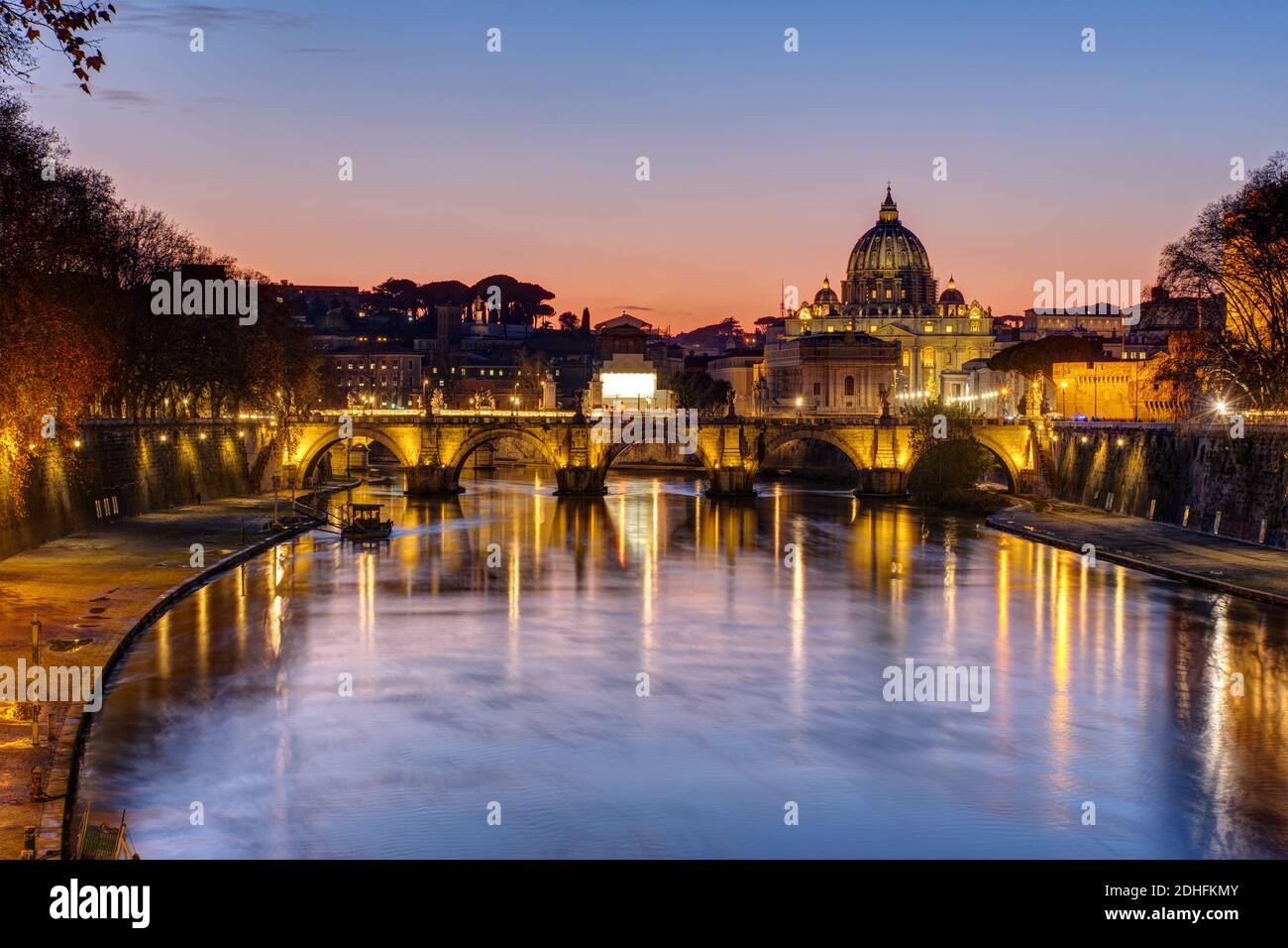 Sunset over the St. Peters Basilica and the river Tiber in Rome Stock Photo