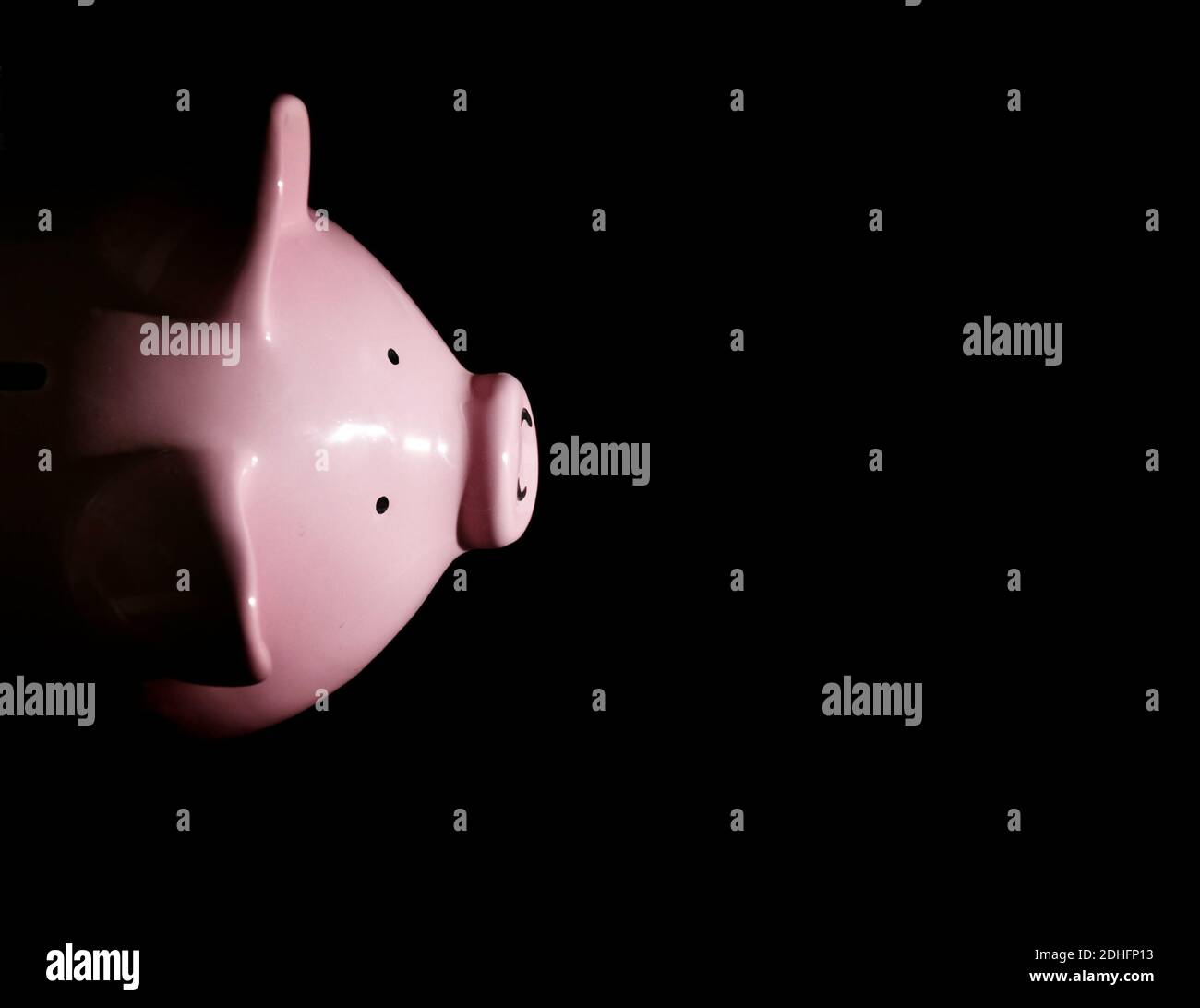 Piggy bank on black background from above Stock Photo
