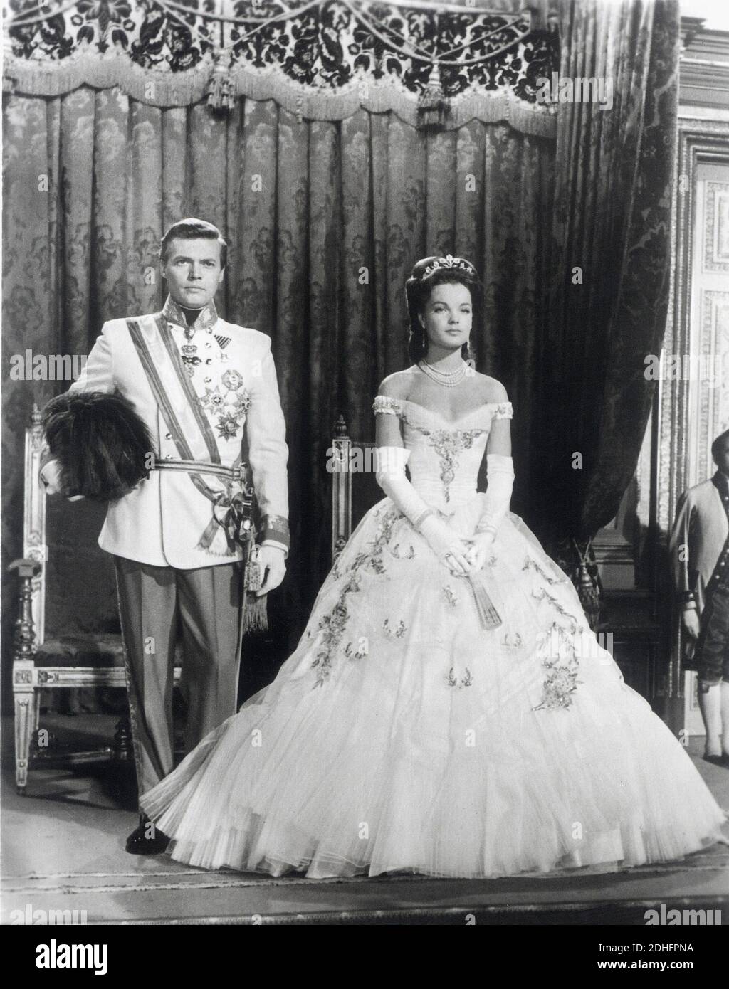 1955 , AUSTRIA :  The movie actress  ROMY  SCHNEIDER ( 1938 - 1982 ) as the Queen of Hungry and  Empress SISSI  Elisabeth Absburg of Austria in   '  Sissi  '  by Ernst Marischka , KARL HEINZ BOHM as the Kaiser Franz Josef  - ATTRICE - MOVIE - FILM - CINEMA - ASBURGO - ABSBURGO -  portrait - ritratto  -  tiara - corona - crown - diamanti - diamonds - diamante - diamond - jewellery - jewel - jewels - gioiello - gioielli  - scollatura - neckline - neckopening  - military uniform uniforme militare - medals - decorations - lace - collana di perle - pearls - pearl - perla  - medaglia - medaglie - de Stock Photo
