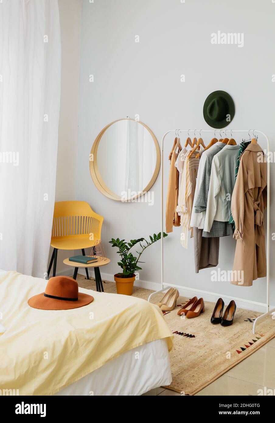 Interior of stylish bedroom with clothes rack Stock Photo Alamy