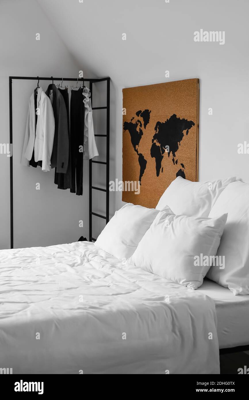 Interior of stylish bedroom with clothes rack Stock Photo Alamy