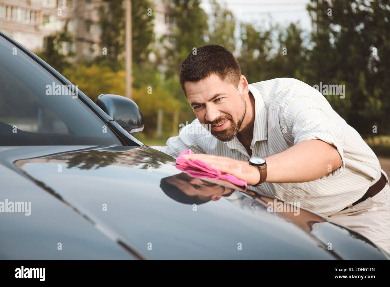 Handsome man washing his car outdoors Stock Photo Alamy