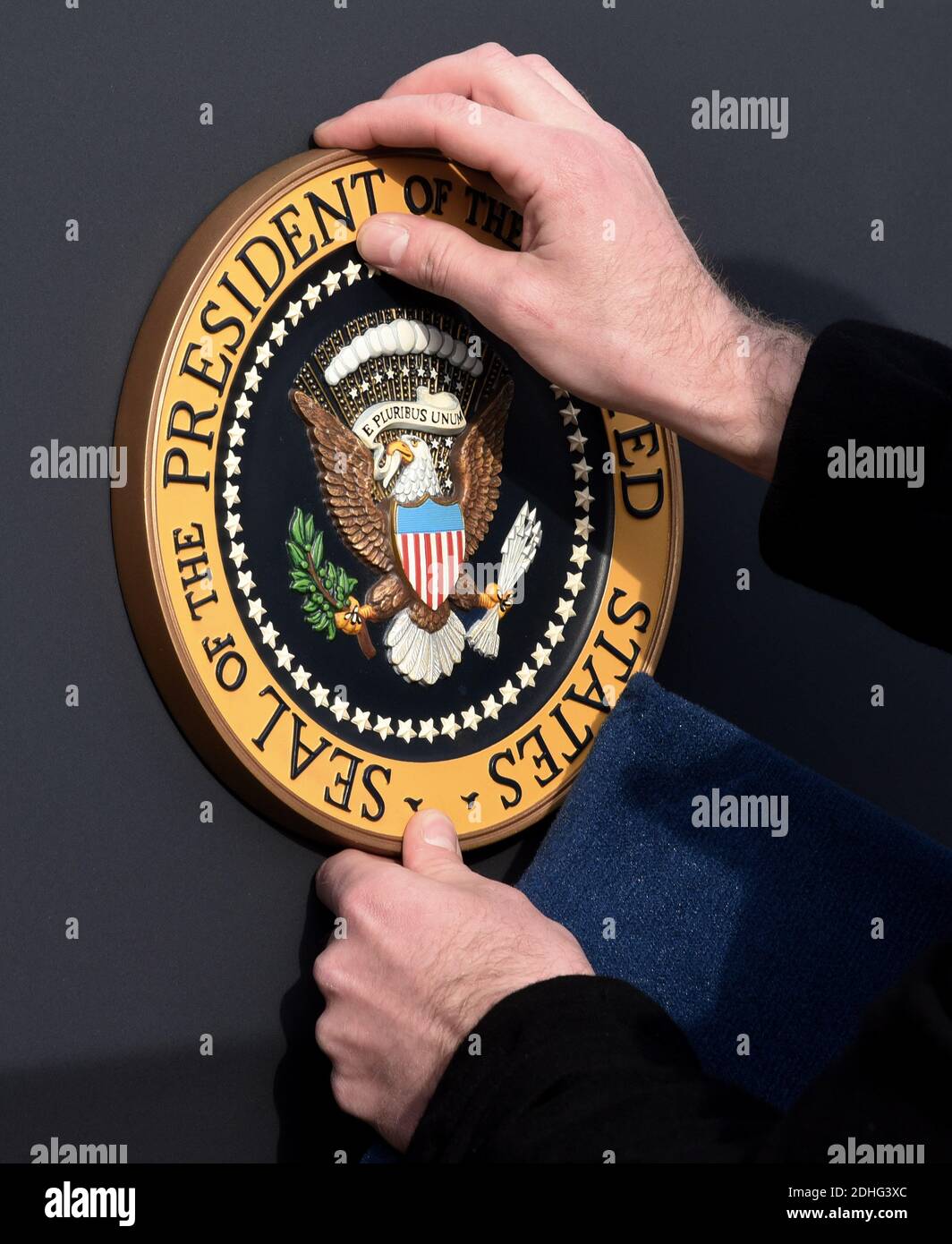 A staff member places the Presidential Seal on the podium prior to US President Donald Trump speaking about the passage of tax reform legislation on the South Lawn of the White House in Washington, DC, December 20, 2017. Photo by Olivier Douliery/Abaca Press Stock Photo