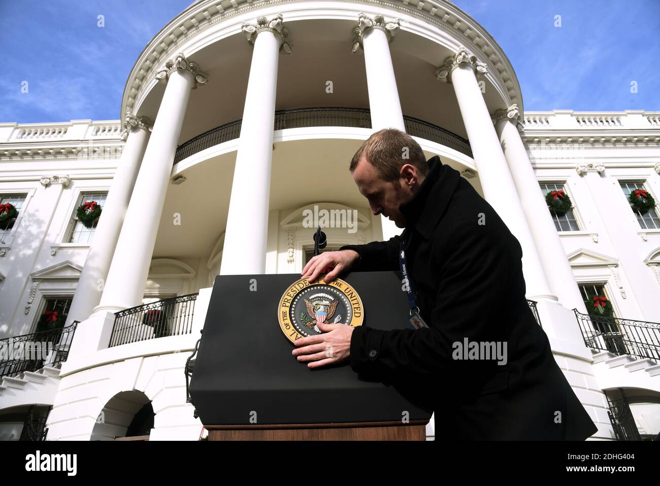 A staff member places the Presidential Seal on the podium prior to US President Donald Trump speaking about the passage of tax reform legislation on the South Lawn of the White House in Washington, DC, December 20, 2017.Photo by Olivier Douliery/Abaca Press Stock Photo