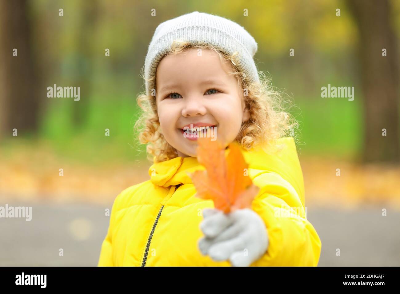 Cute little girl in autumn park Stock Photo - Alamy