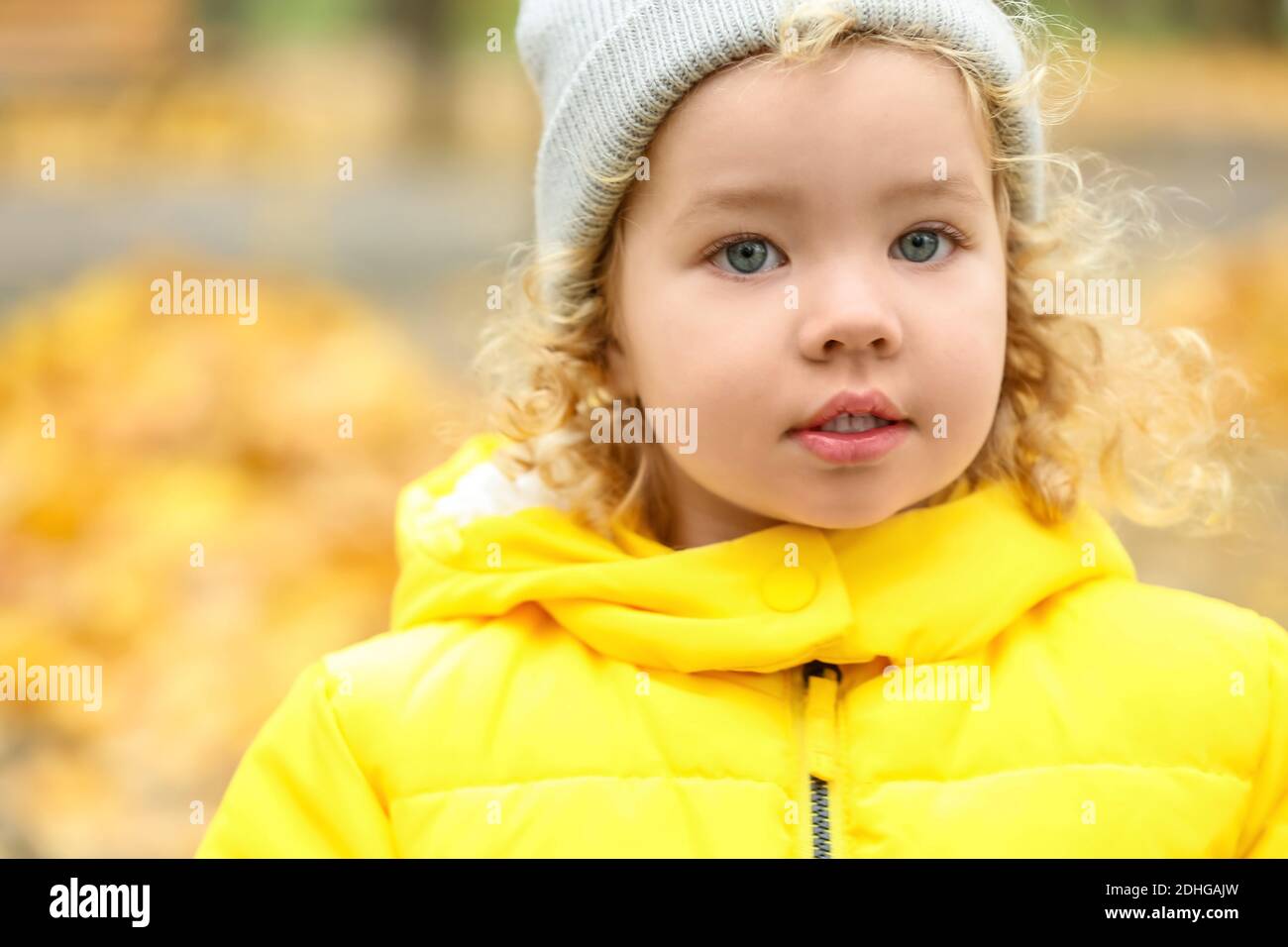 Cute little girl in autumn park Stock Photo - Alamy