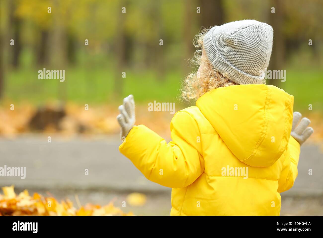 Cute little girl in autumn park Stock Photo - Alamy
