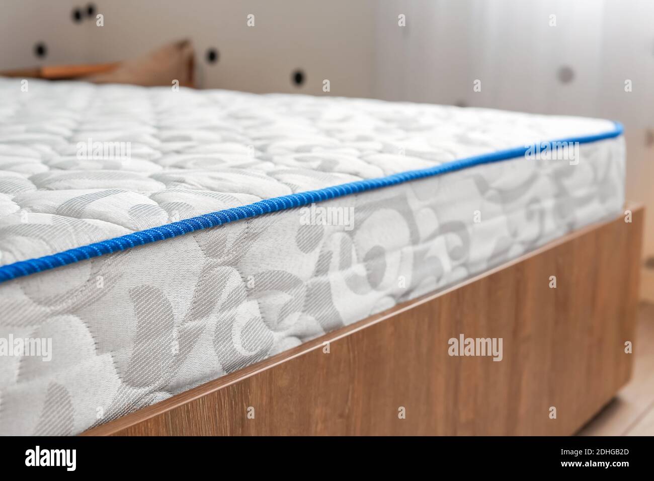 Modern orthopedic mattress on bed in room Stock Photo Alamy