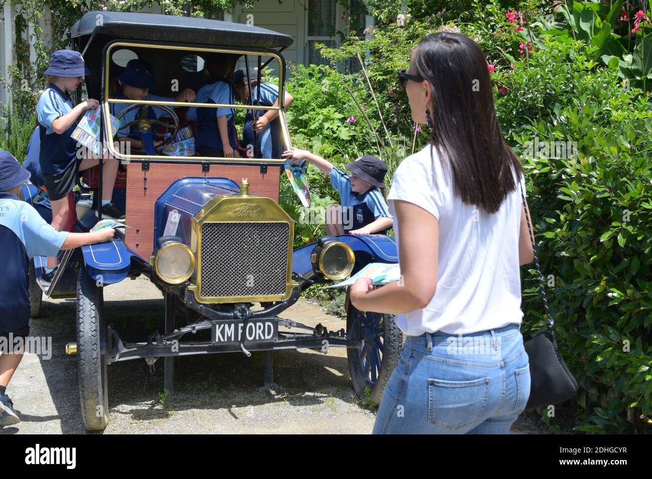 HAMILTON, NEW ZEALAND - Dec 02, 2020: View of group of school kids climbing Ford Model T in Mansfield Garden (Hamilton Gardens) Stock Photo