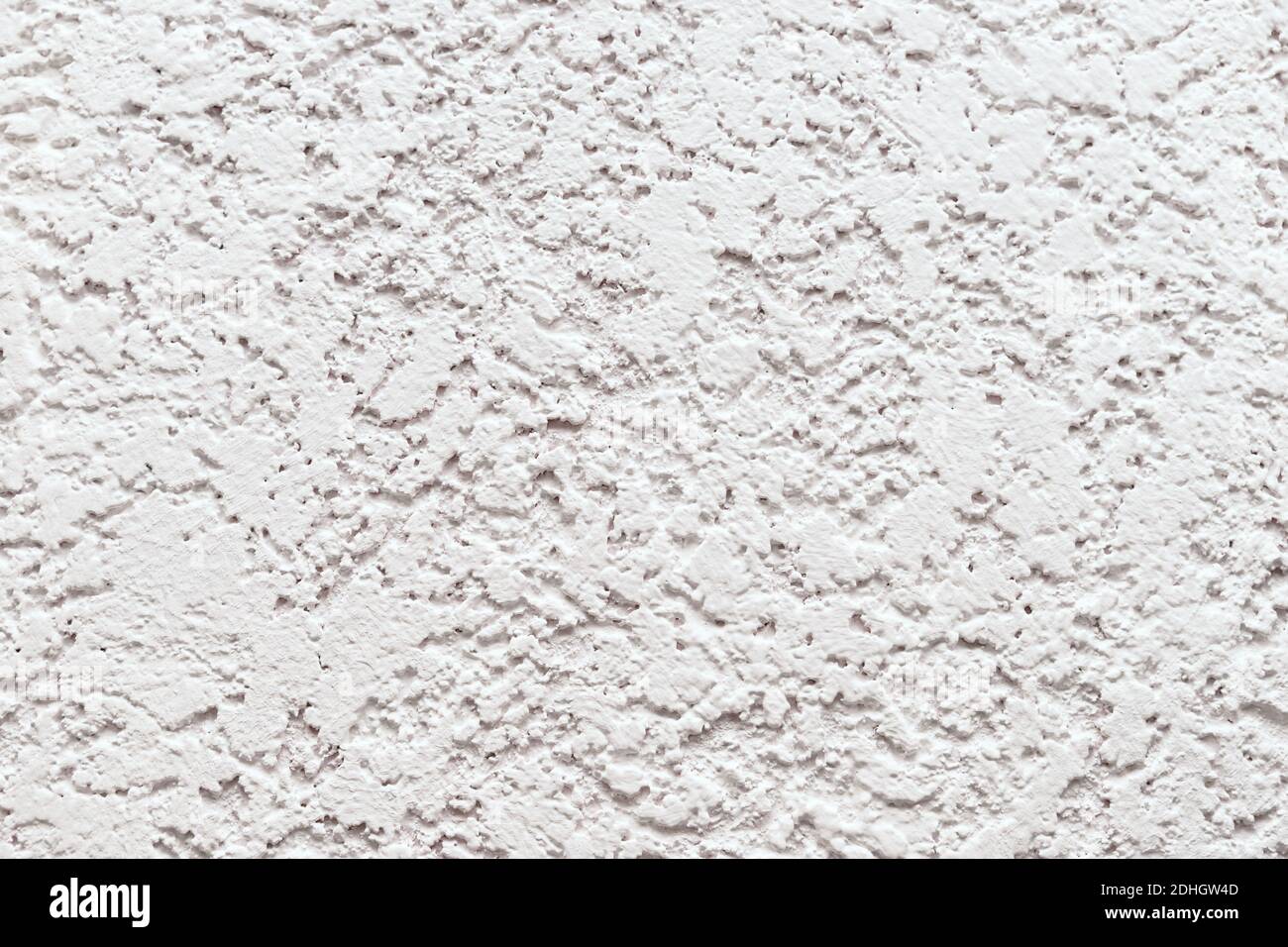 Embossed white wall trimmed with decorative plaster. Stock Photo