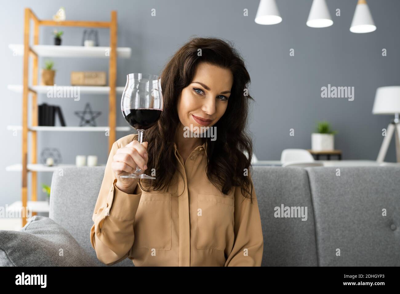 Woman Drinking Red Wine In Video Conference At Home Stock Photo - Alamy