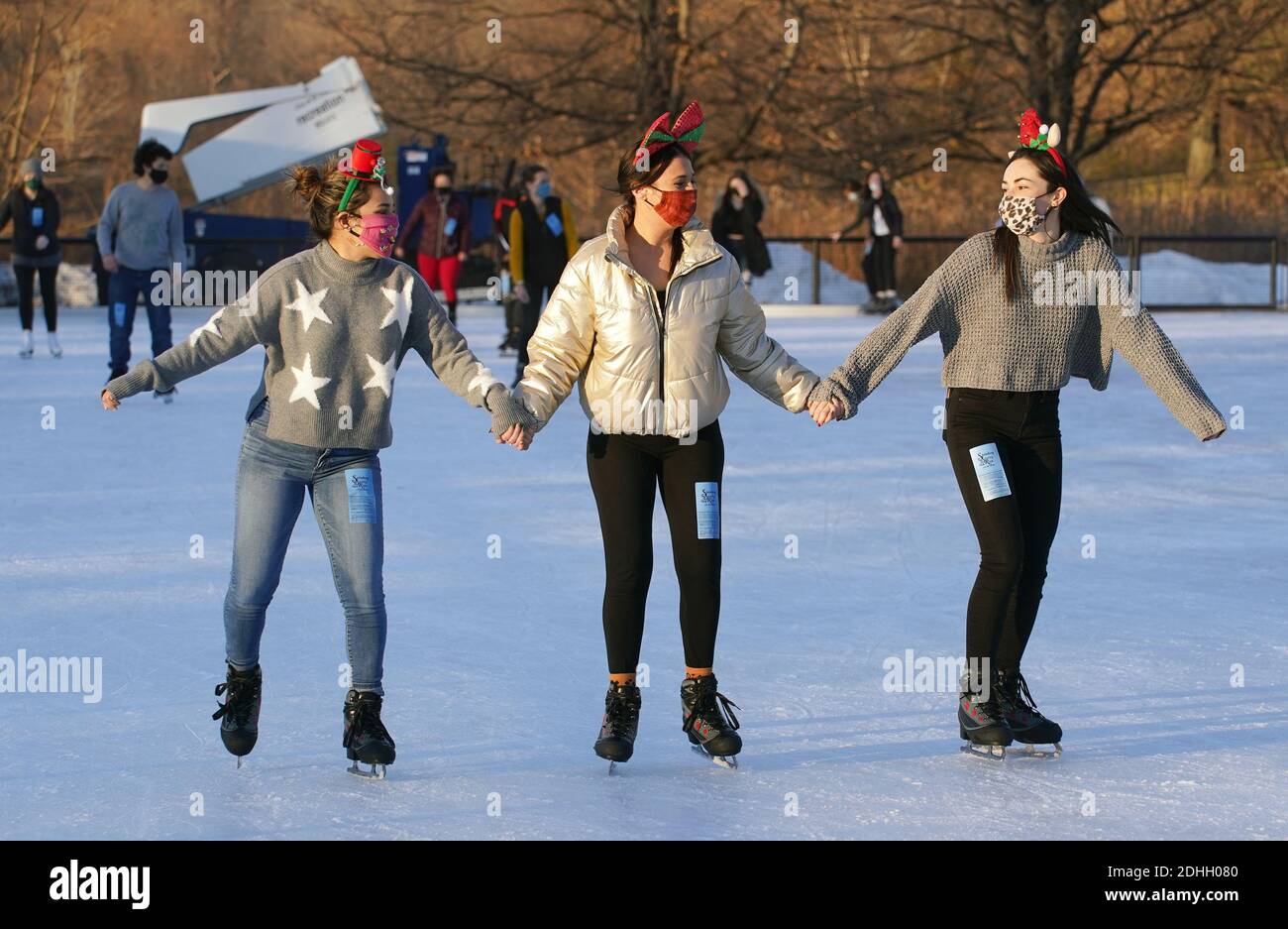 St. Louis, United States. 10th Dec, 2020. Skaters (L to R) Gabby Garcia, Alex Behlmann and Mia Eckl, hold hands as they skate in circles at Steinberg Ice Rink in St. Louis on Thursday, December 10, 2020. Unseasonable warm temperatures reached 70 degrees on the day, with colder temperatures expected for the weekend. Photo by Bill Greenblatt/UPI Credit: UPI/Alamy Live News Stock Photo