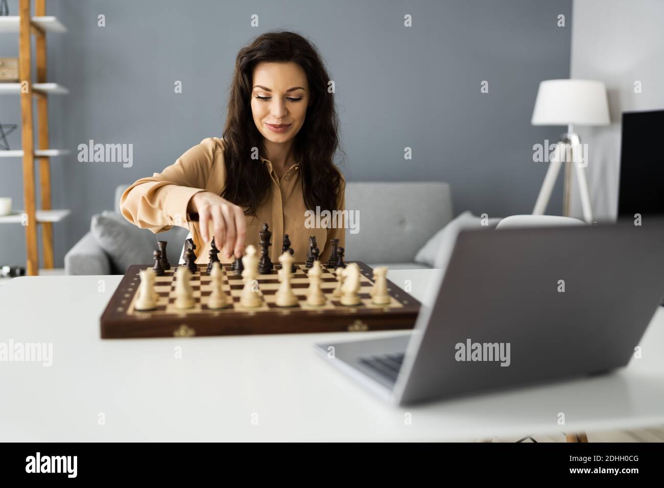 Woman Playing Chess Online Using Video Conference Call Stock Photo