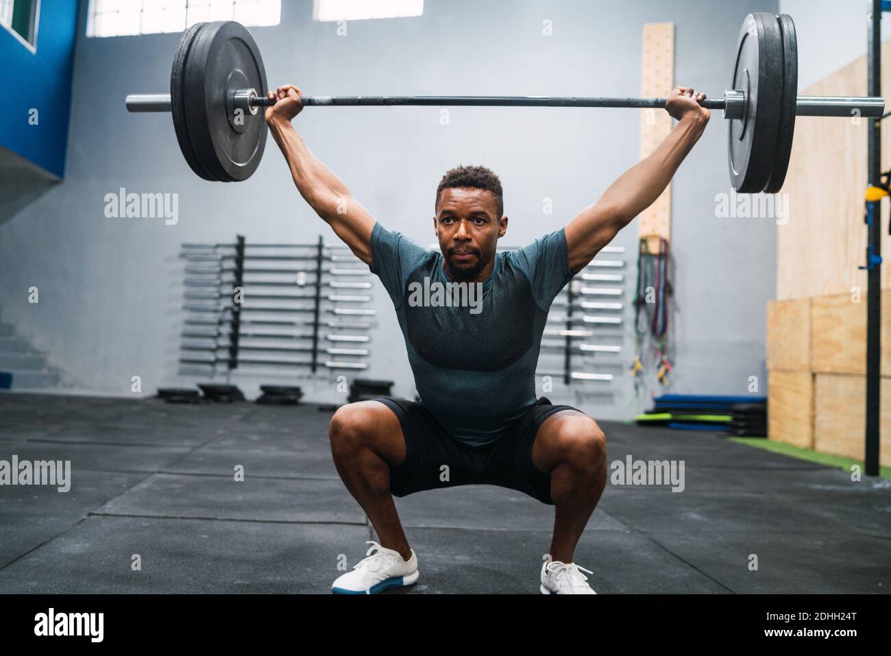 Crossfit athlete doing exercise with a barbell Stock Photo - Alamy