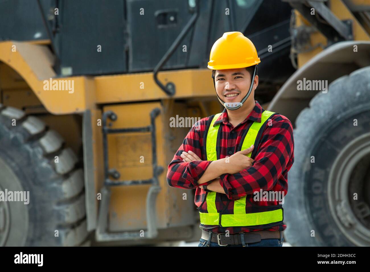 Construction Safe Driver Asian driver wear safety uniform backhoe excavator and bulldozer on ...