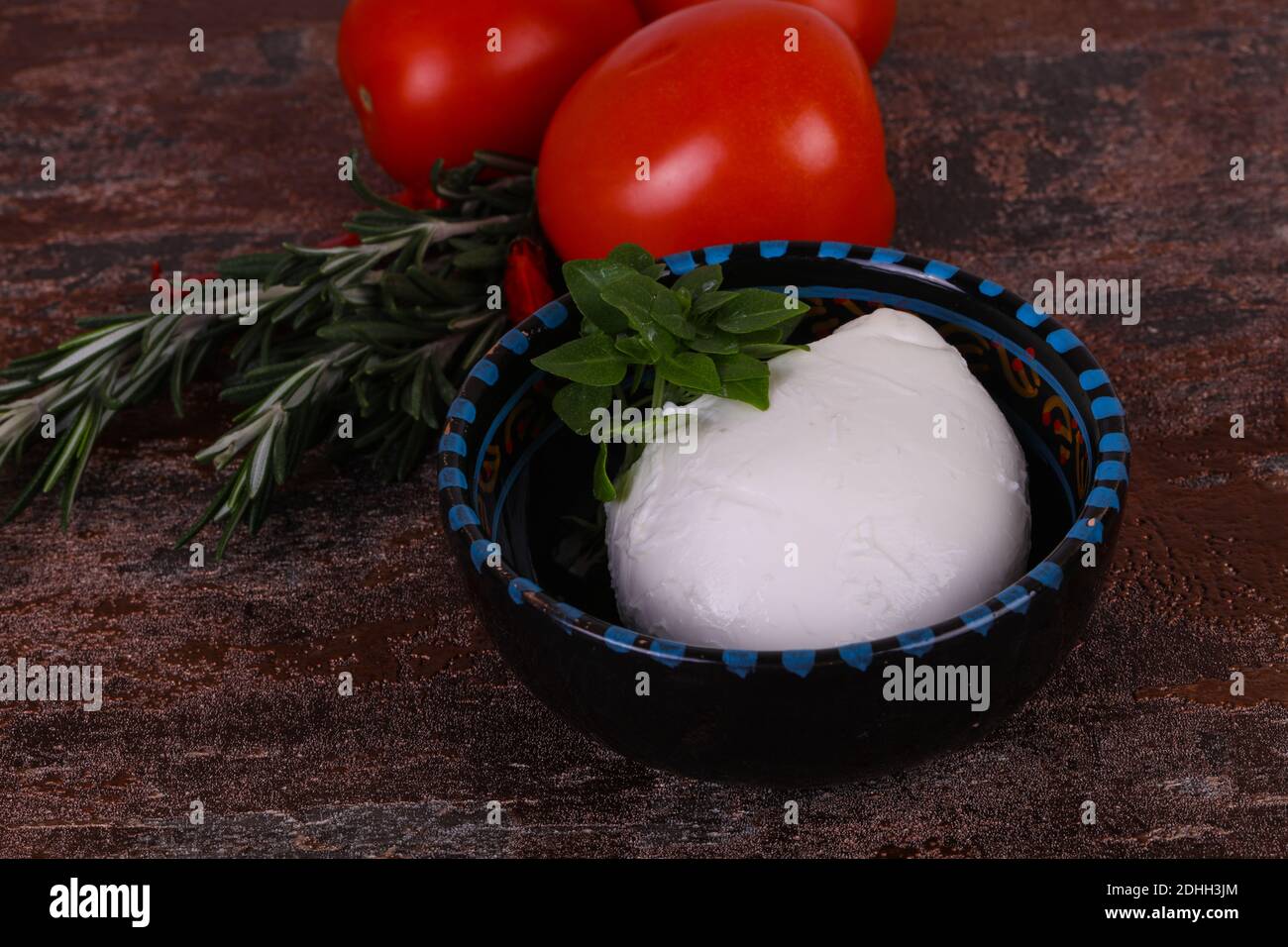 Italian Mozzarella cheese ball served basil and tomatoes Stock Photo Alamy