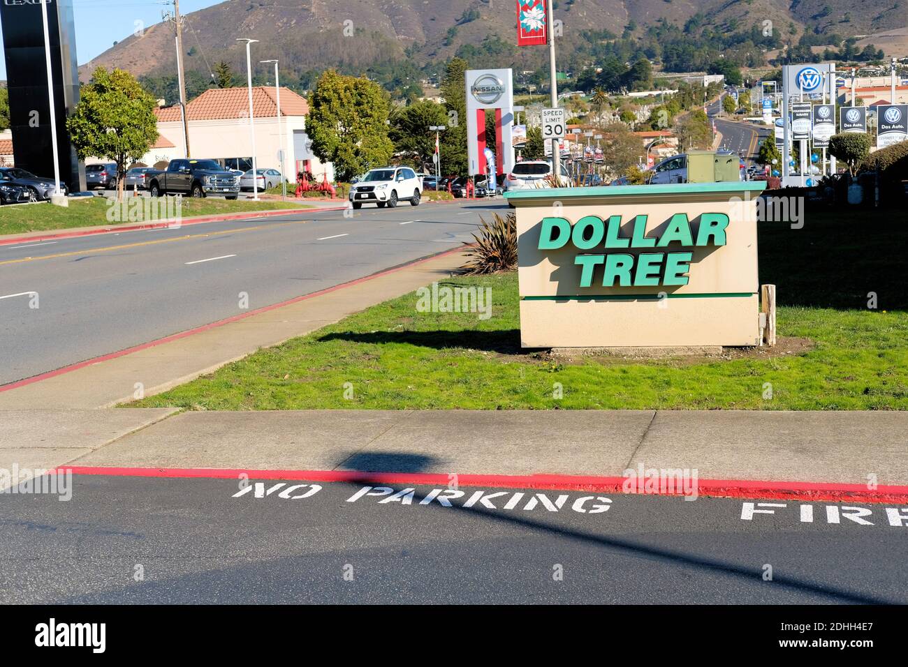 Dollar Tree store sign at the entrance to its parking lot with a view of the street in Colma, California, USA. Stock Photo