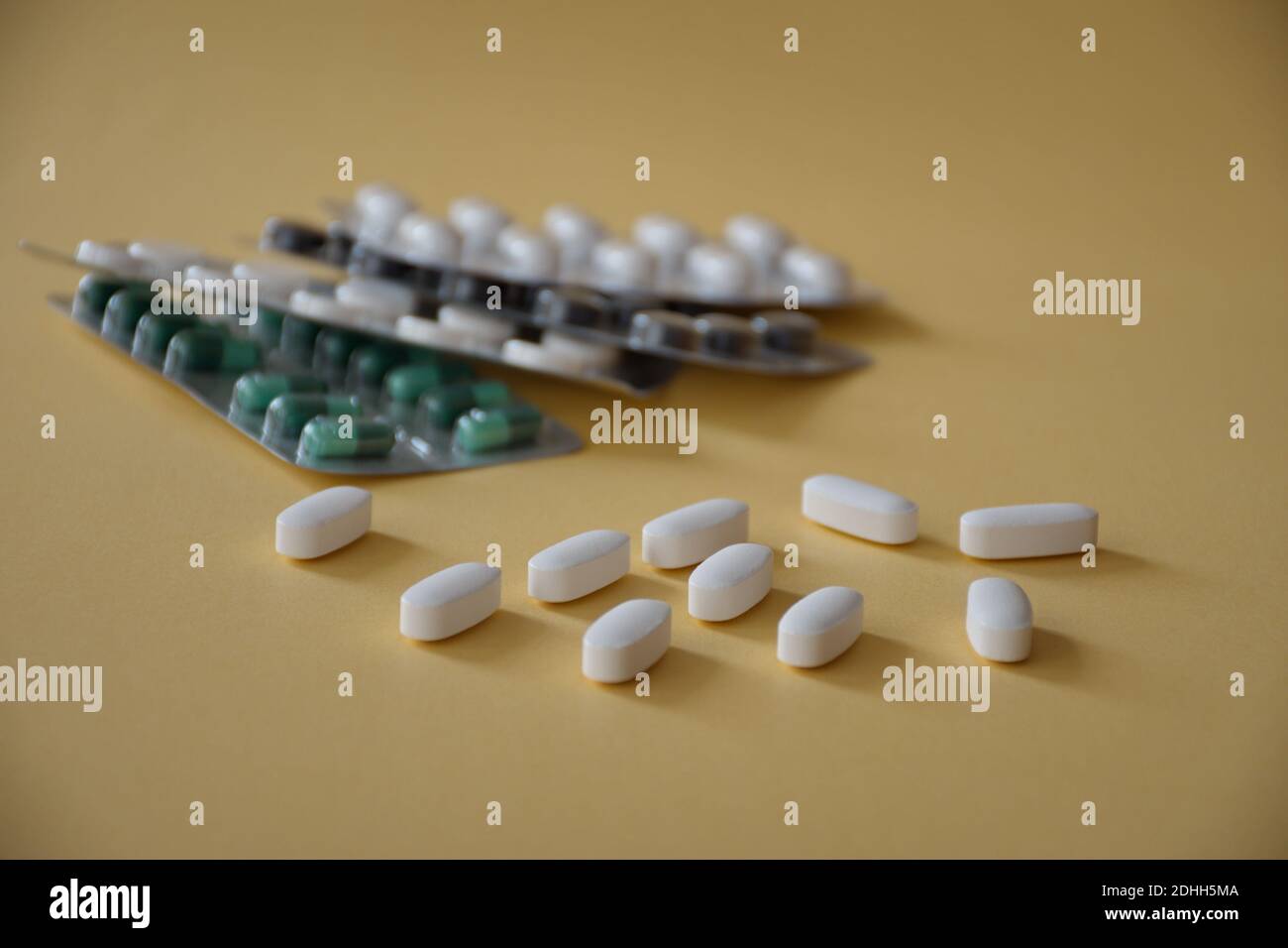 Various capsules and pills on beige background Stock Photo
