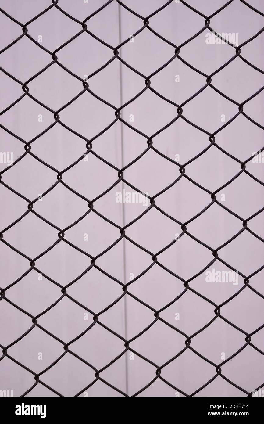 A vertical shot of a grid fence Stock Photo - Alamy