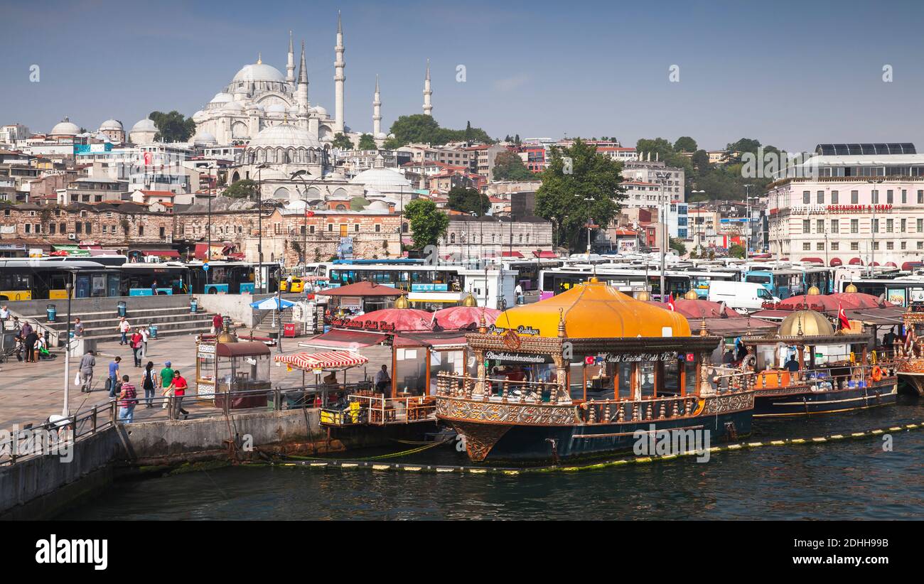 Istanbul, Turkey - July 1, 2016: Istanbul view, Eminonu district. Ordinary people are on the coast of Golden Horn, Suleymaniye Mosque is on a backgrou Stock Photo