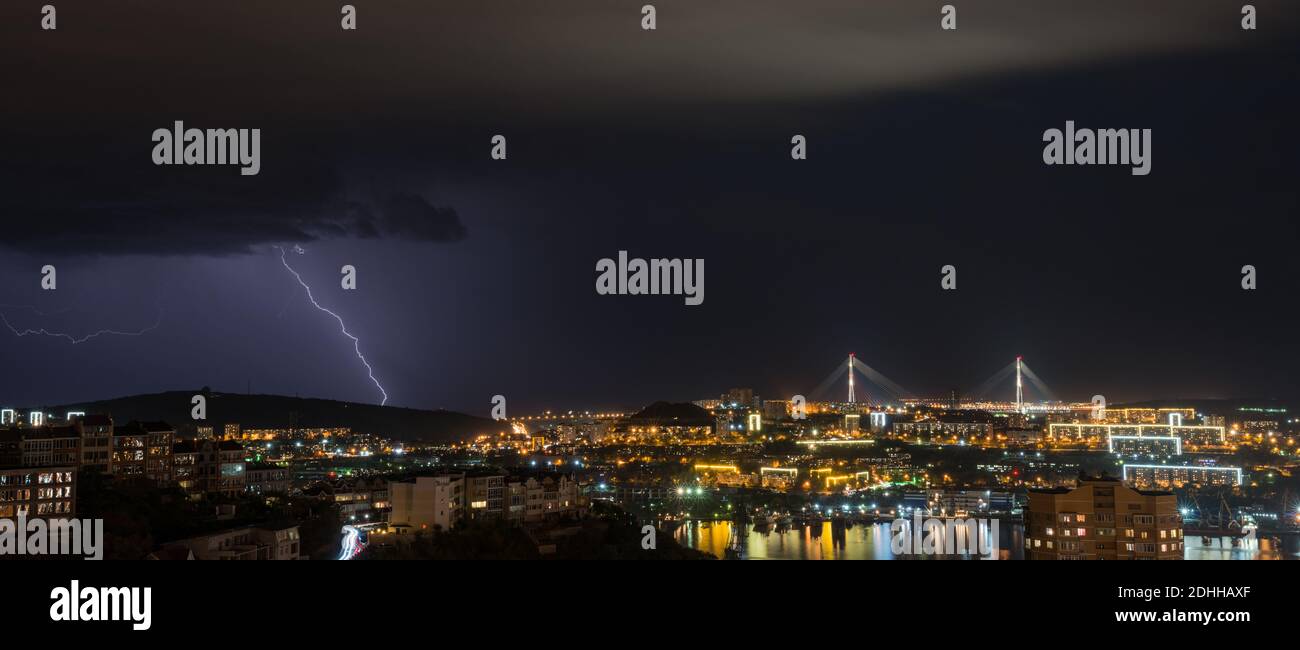 Lightning storm over night city Stock Photo - Alamy