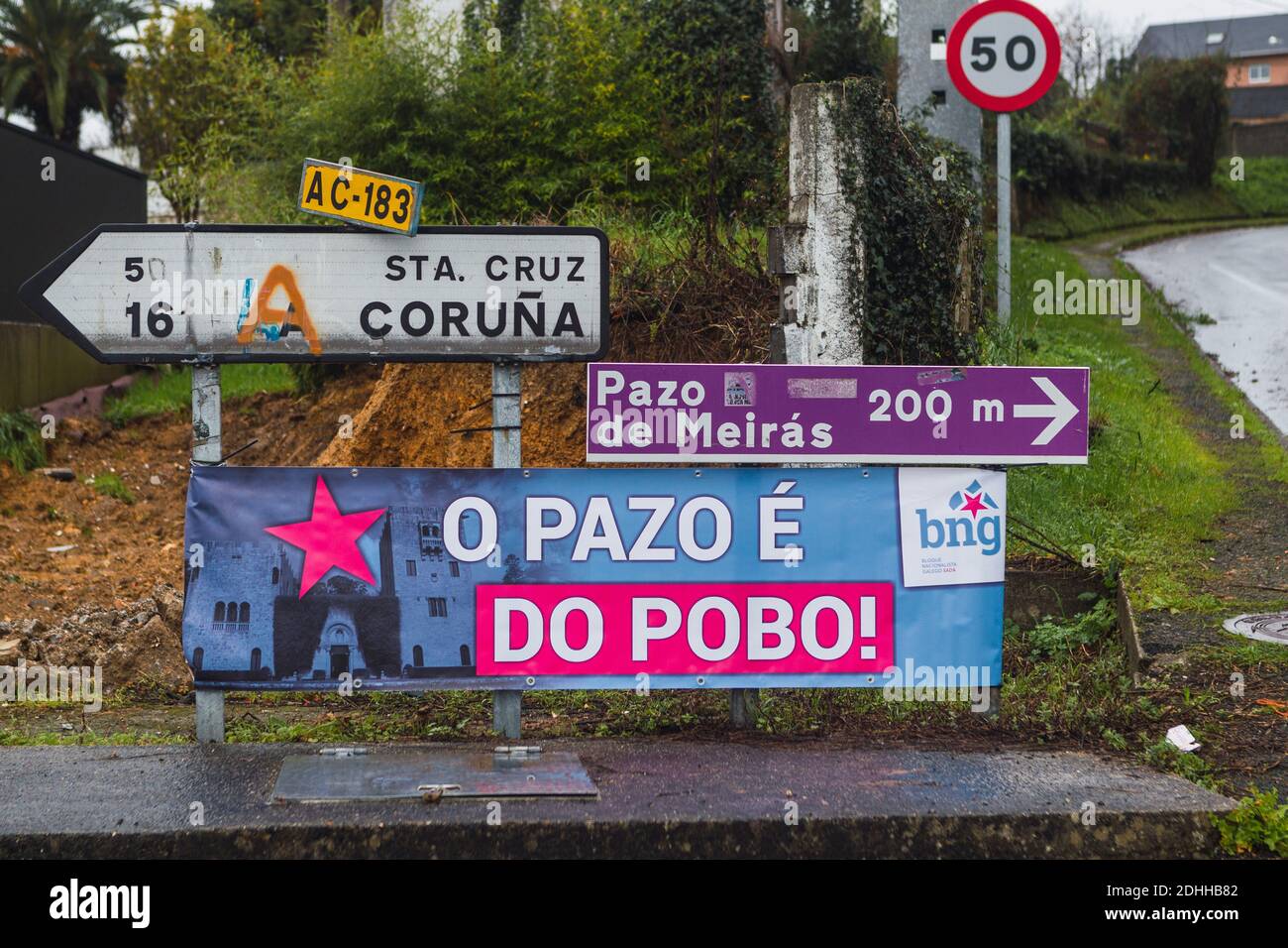 Meirás-Coruna-Spain. Poster placed next to several kilometric signs that indicates that the pazo de Meiras belongs to the town on December 10, 2020 Stock Photo