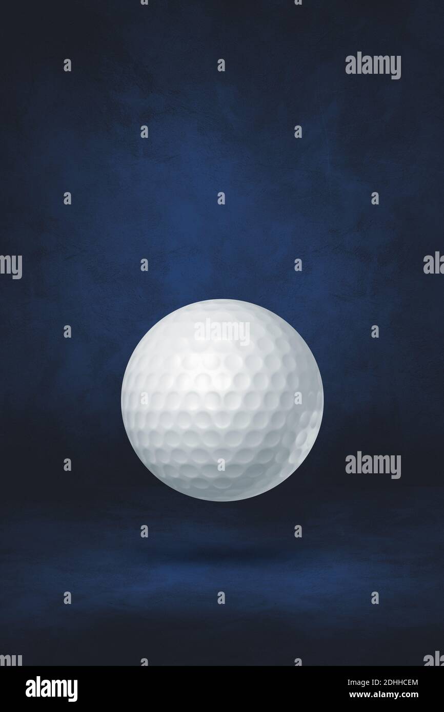 White golf ball isolated on a dark blue studio background. 3D