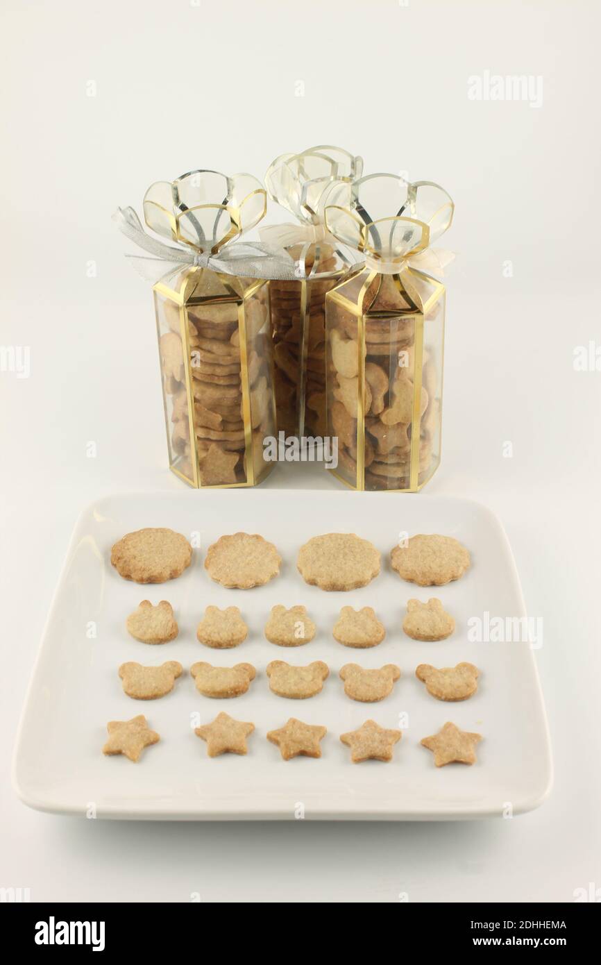 Homemade Christmas cookies in the shape of flowers, rabbits, teddy bear and stars, isolated on a white background Stock Photo