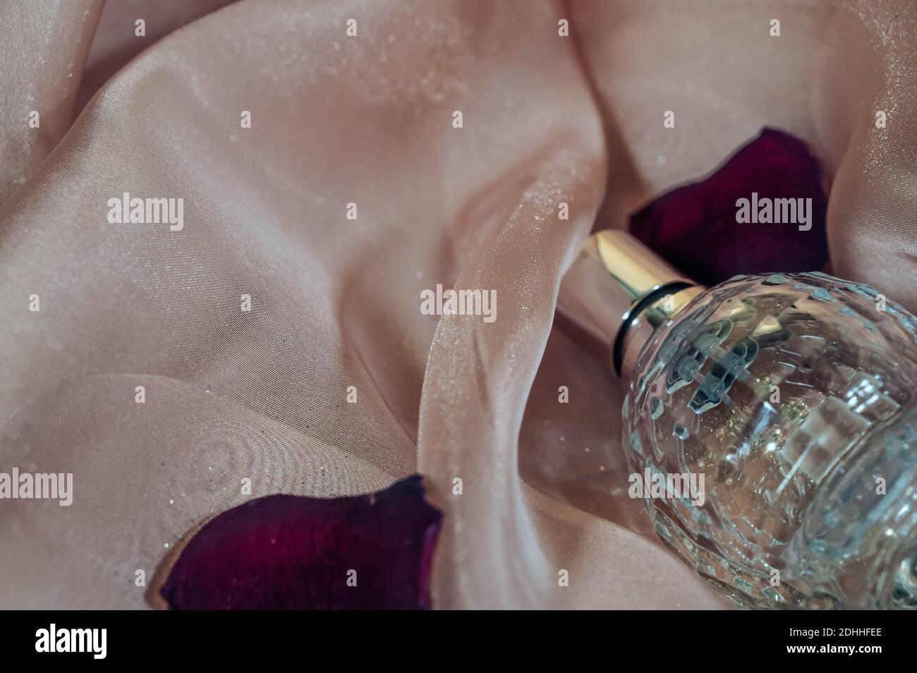 Bottle of woman perfume isolated on gold background with copy space. Stock Photo