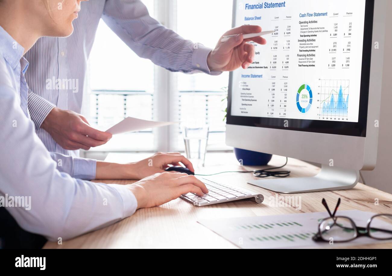 Accountants working on financial statement on computer screen in office. Team of consulant auditing finance and business operations reports with incom Stock Photo