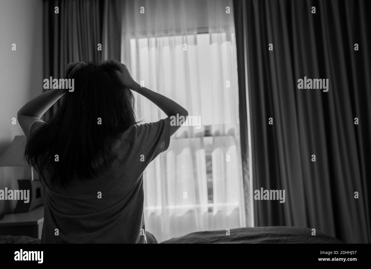 Selective focus on stressed and depressed woman holding head and pulling hair. Nervous person. Mental health and dementia. Worry and anxiety woman. Stock Photo