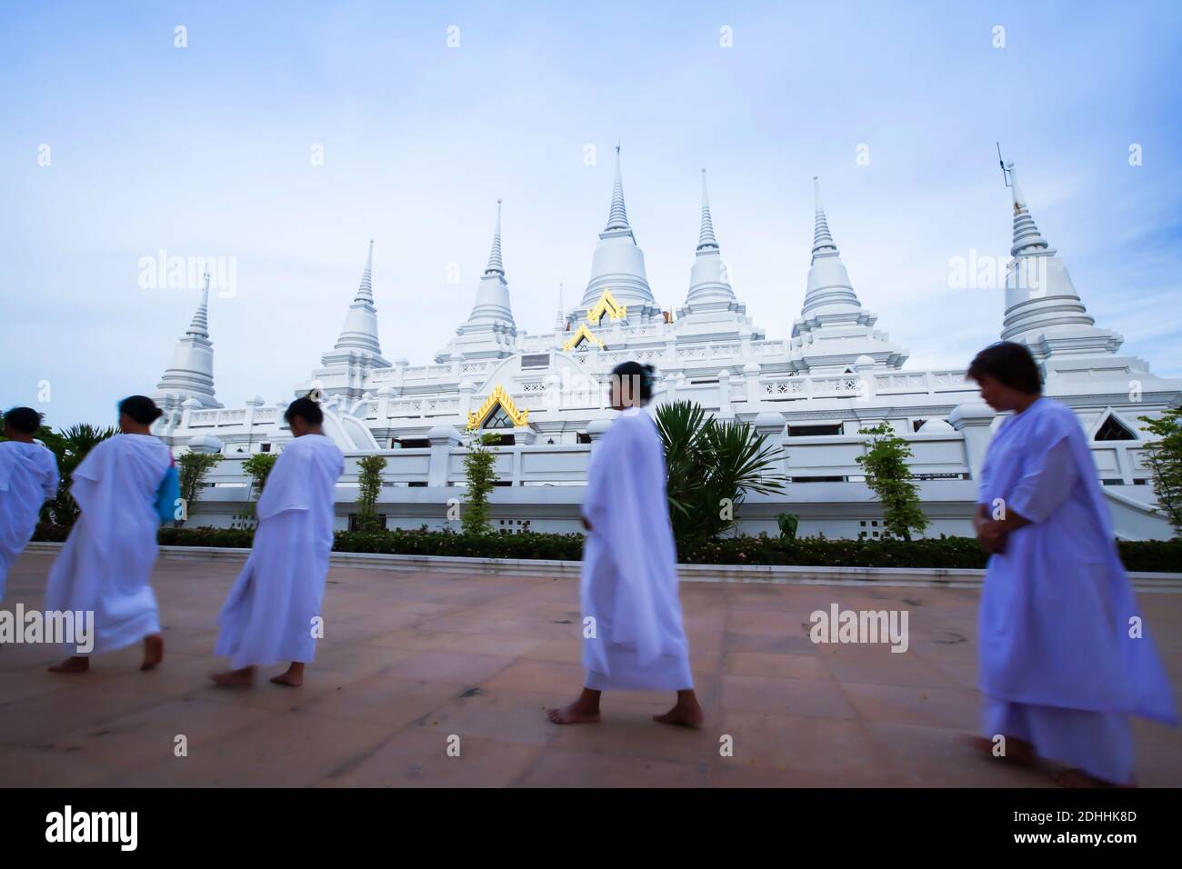 A group of Buddhist women in traditional clothing are practices Dharma