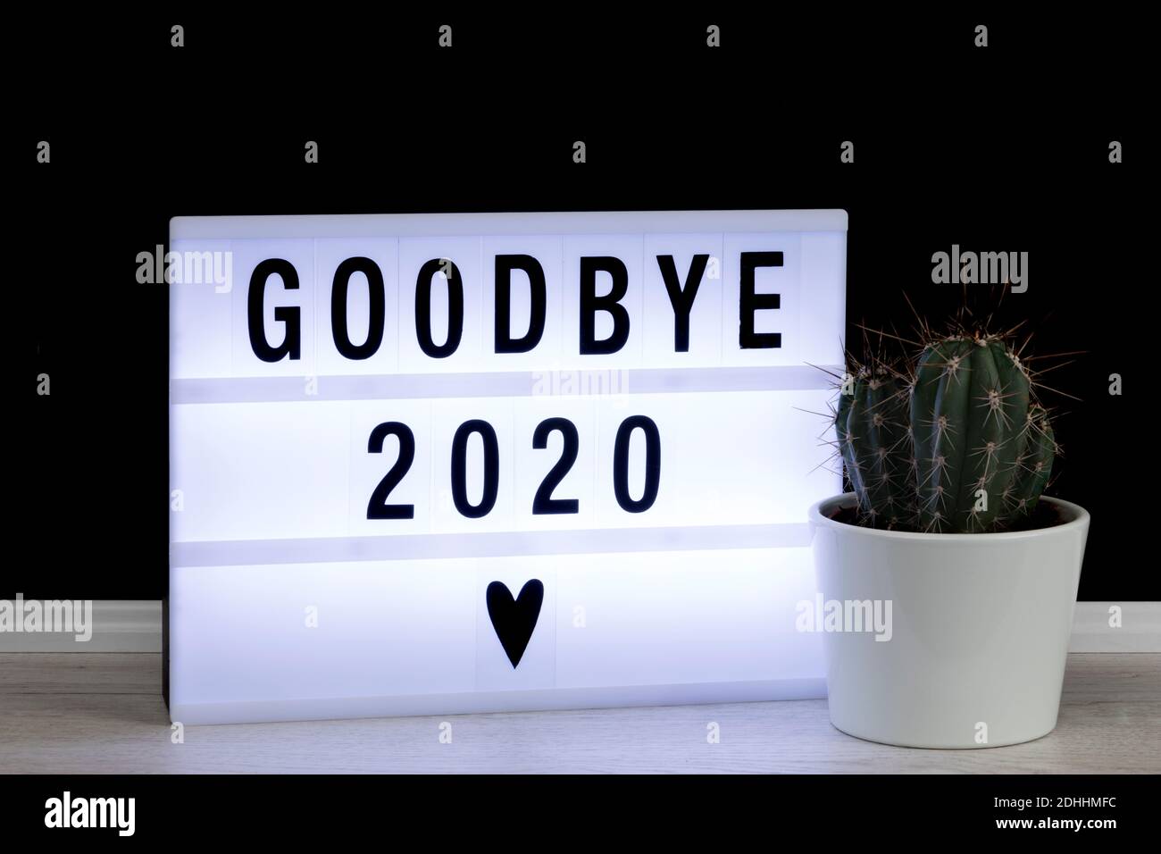 Farewell to a bad year 2020. Lightbox with goodbye message and potted cactus. Stock Photo