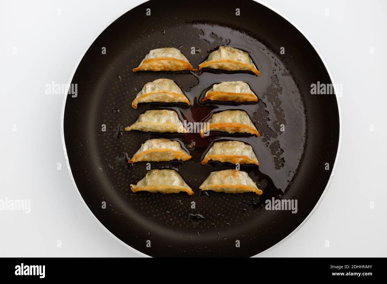Frozen dumplings fried in oil on a frying pan Stock Photo Alamy