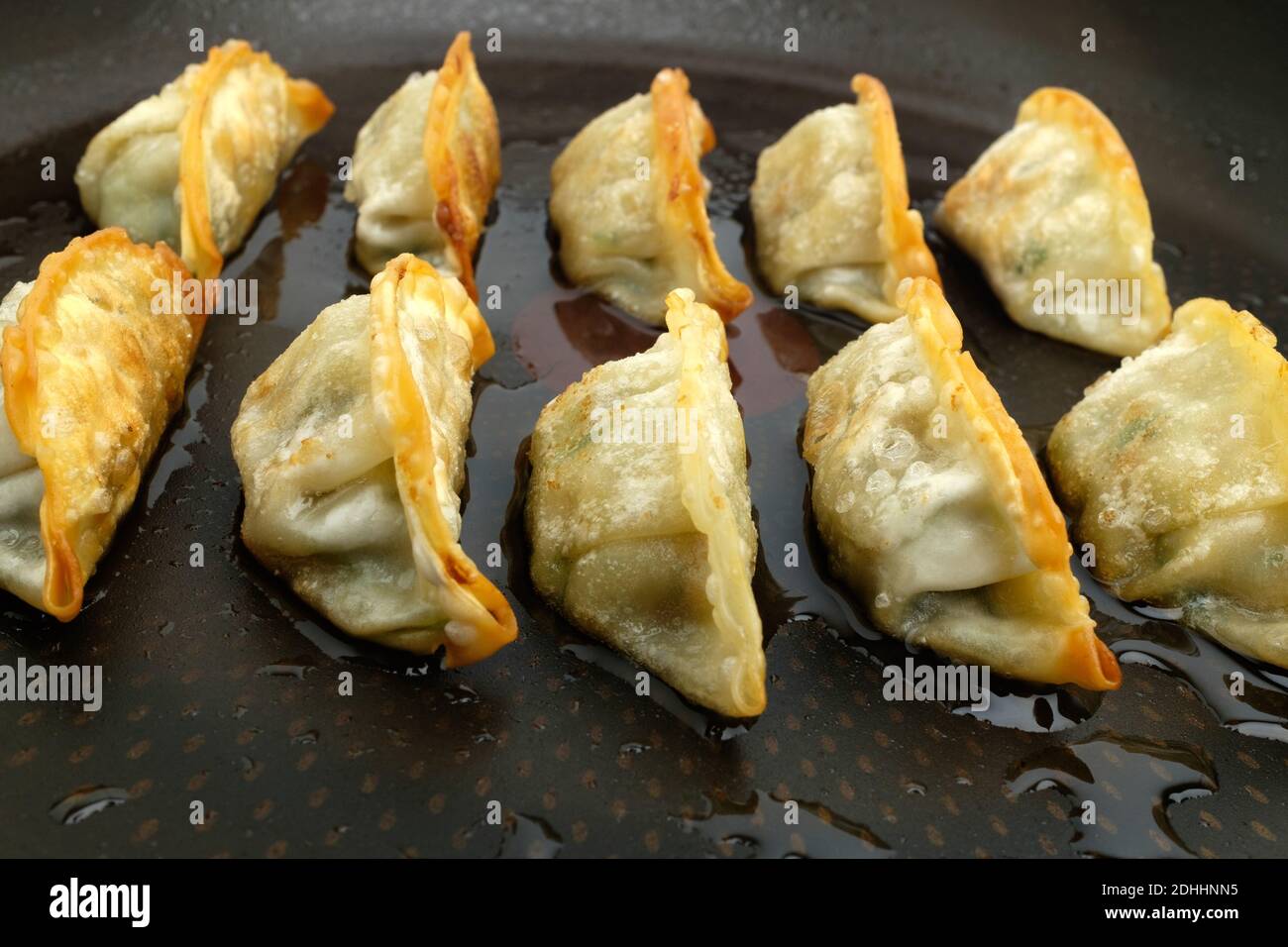 Frozen dumplings fried in oil on a frying pan Stock Photo Alamy