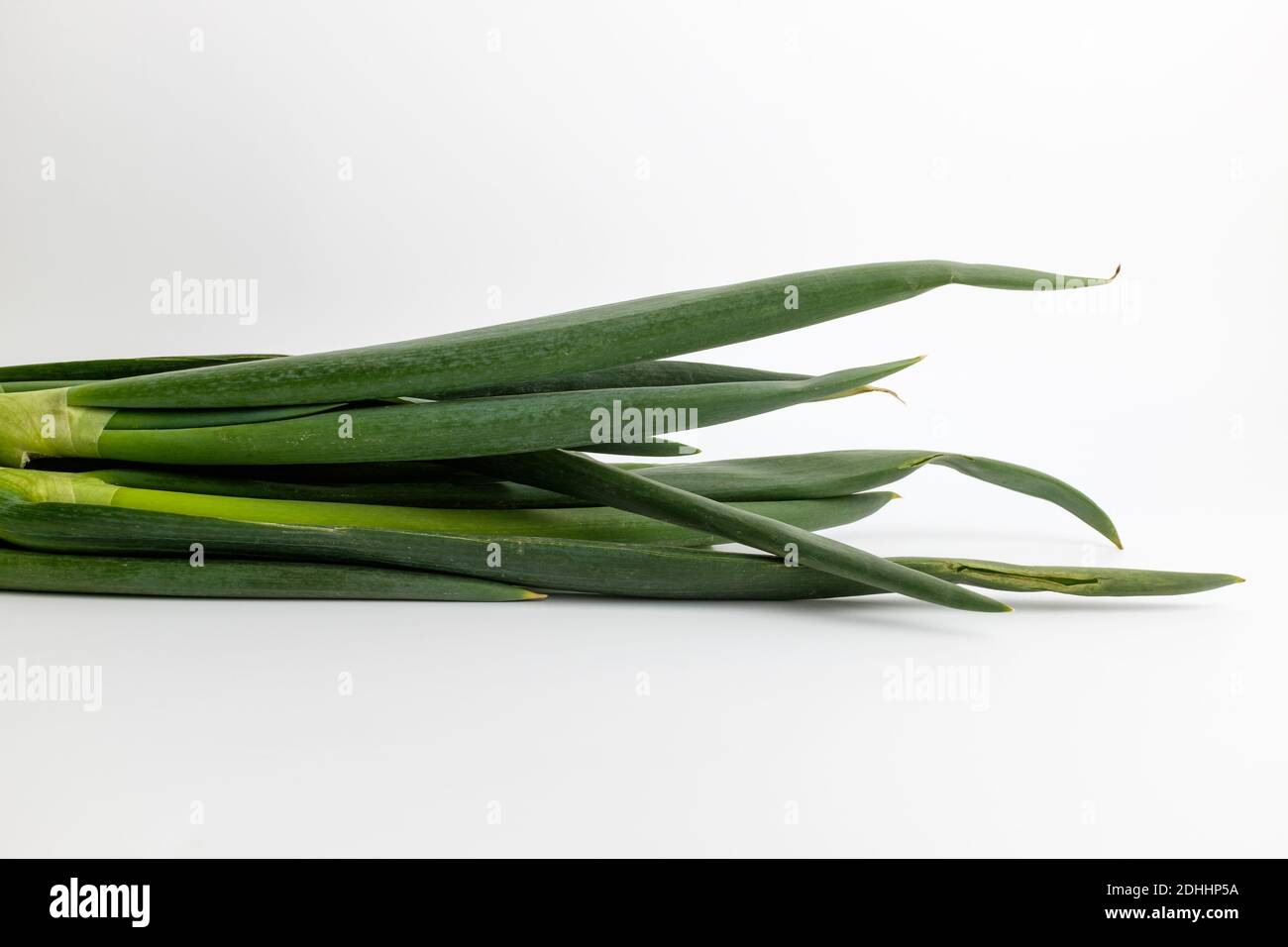 Fresh green onions on white background Stock Photo - Alamy