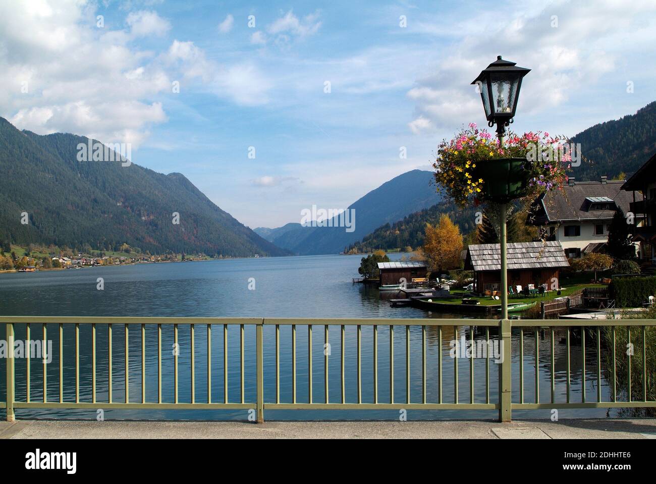 Austria, Carinthia, bridge over Weissensee lake with flower covered lantern Stock Photo