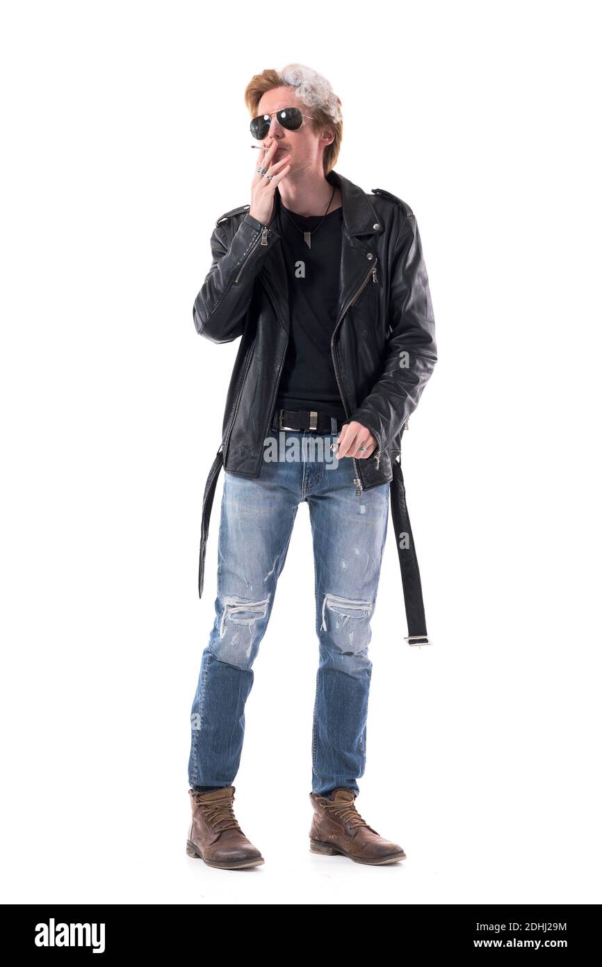 Cool macho confident biker style young man with sunglasses smoking cigarette exhale smoke. Full body length isolated on white background. Stock Photo