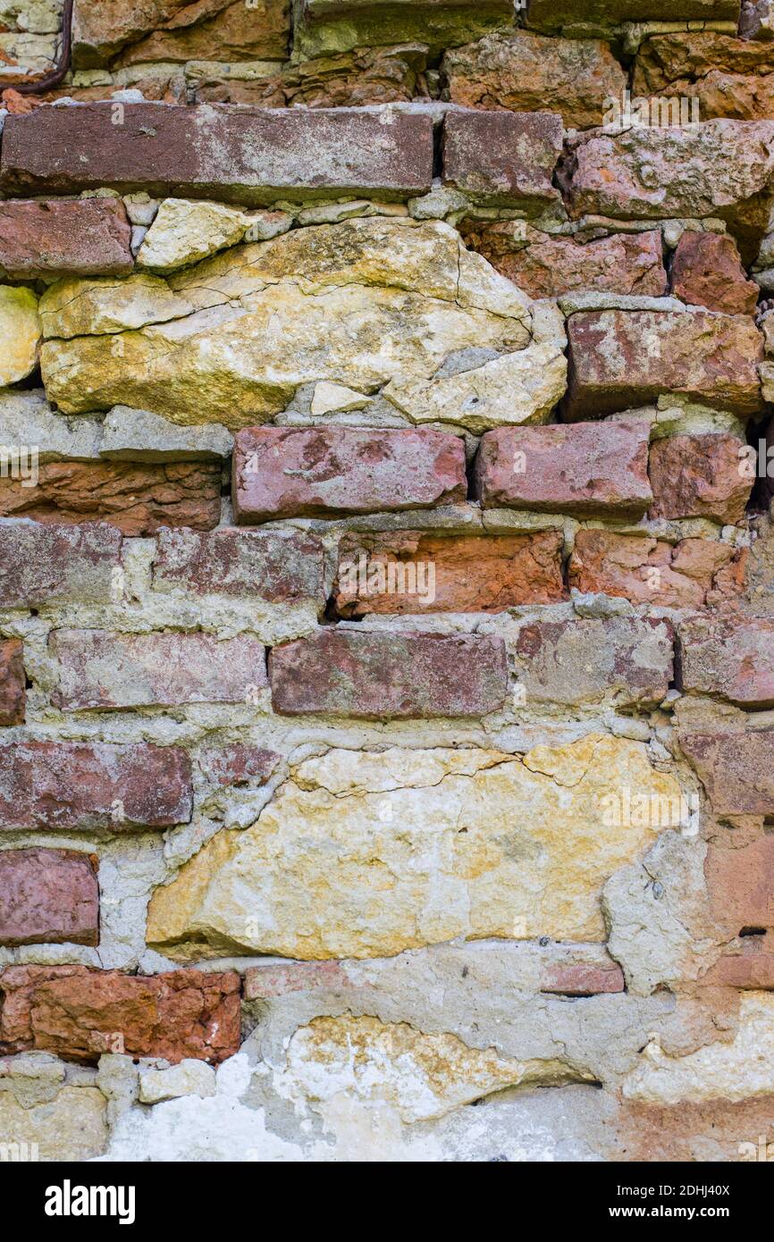 abstract backgrounds: ancient ruined red brick wall with lime stones Stock Photo
