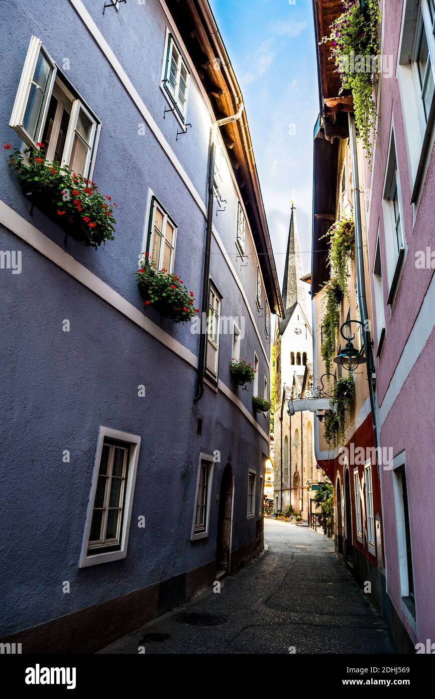 Narrow Alley With Historic Buildings And View to Church In Picturesque Lakeside Town Hallstatt In Austria Stock Photo