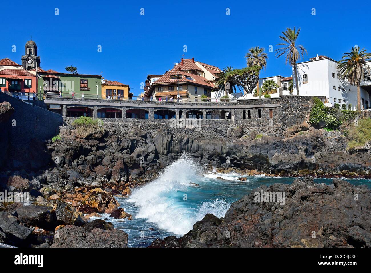 Tenerife, Canary Islands, Spain - April 03, 2018:  Unidentified people at Punte del Viento in Puerto de la Cruz, a preferred seaside spot, tower of ch Stock Photo
