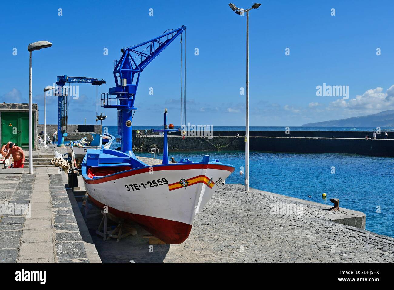 Tenerife, Canary Islands, Spain - April 03, 2018:  Unidentified people and cranes on tiny harbor at Playa del Muelle in Puerto de la Cruz Stock Photo