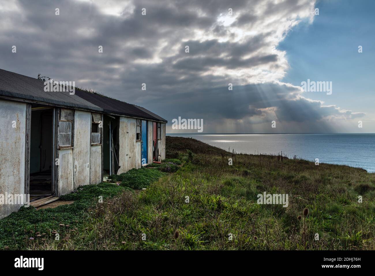 Derelict holiday chalets abandoned due to cliff erosion, Brighstone Bay