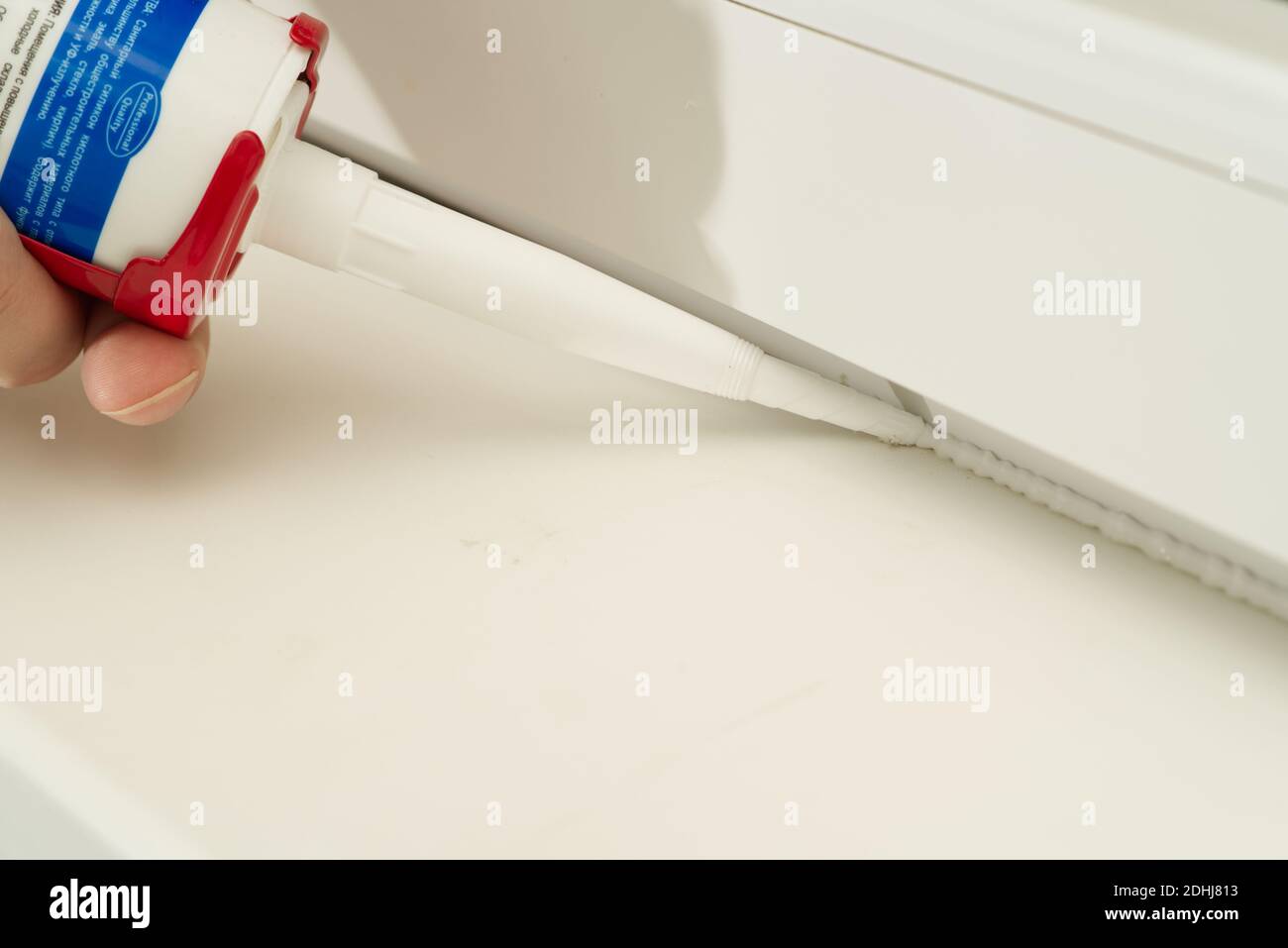 nozzle from which the silicone sealant flows, sealing the gap between Stock Photo Alamy