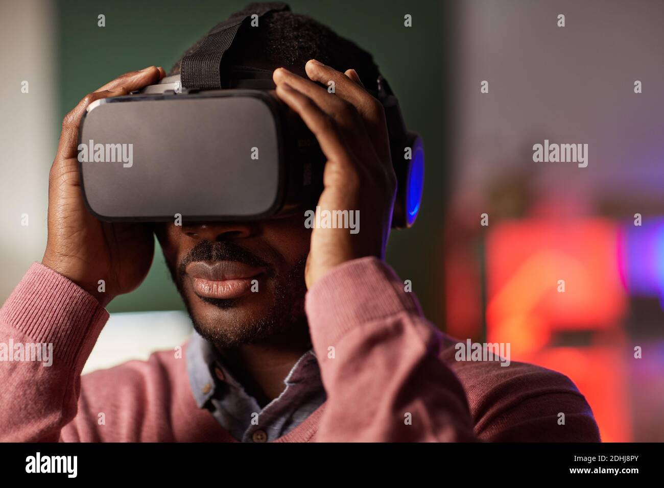 Close-up of African young man wearing glasses during virtual reality game Stock Photo