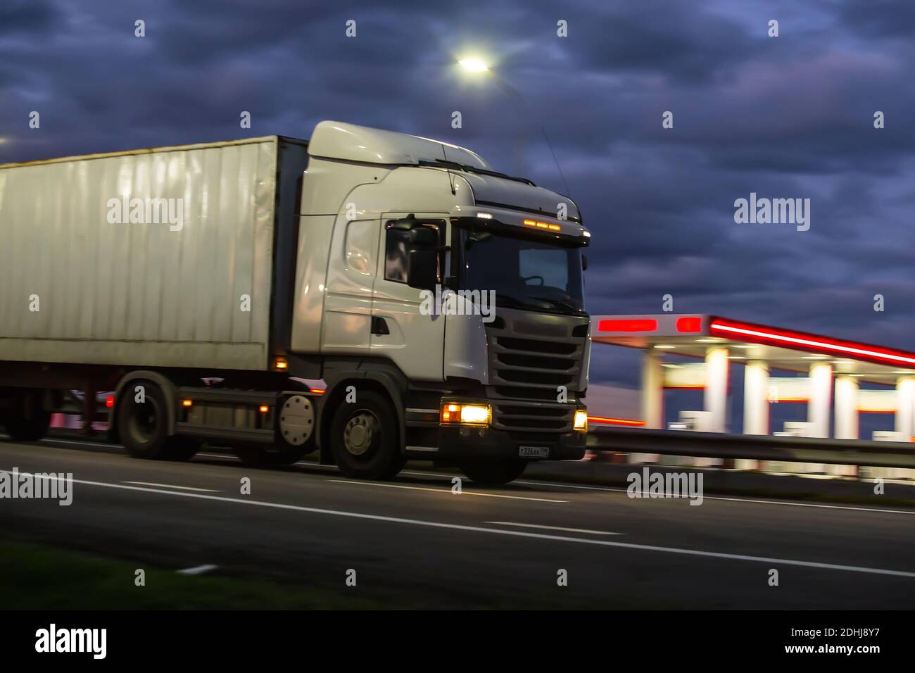 truck moves on country highway at night Stock Photo