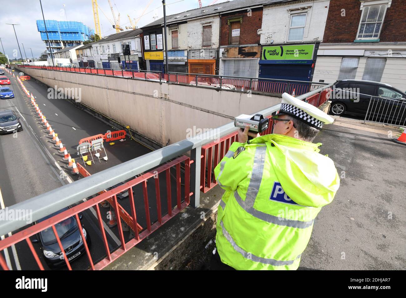 Police traffic officer holding speed checks over the A34 underpass as transport bosses have launched a clampdown on speeding motorists through 20mph road works on Aldridge Road and A34 junctions to make way for major regeneration. Officers from West Midlands Police will be holding regular speed checks as working contractors carryout construction around the Perry Barr area, Birmingham, The Midlands, England. Stock Photo